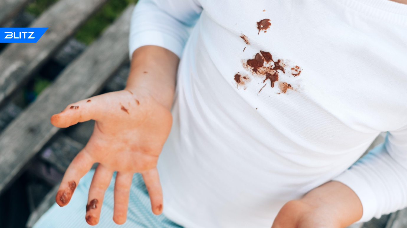 Child eating a Stain on his Shirt
